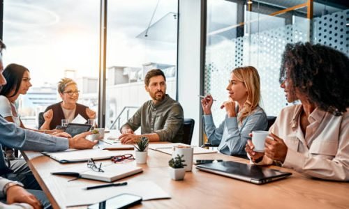 Business concept. Multinational professionals business people discussing daily topics by table in modern office. Business meeting.